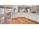 Spacious kitchen with wood floors, white cabinets and access to a breakfast nook at 811 Weeping Willow Dr, Powder Springs, GA 30127