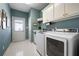 Well-equipped laundry room with modern washer and dryer, ample storage space and natural light at 811 Weeping Willow Dr, Powder Springs, GA 30127