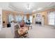 Spacious living room features a marble fireplace and plenty of natural light through large windows at 811 Weeping Willow Dr, Powder Springs, GA 30127