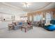 Bright living room with an open floor plan, plush couches, and large windows at 811 Weeping Willow Dr, Powder Springs, GA 30127