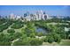 Aerial view of Piedmont Park, lake, Atlanta skyline and surrounding mature trees at 1029 Piedmont Ne Ave # 101, Atlanta, GA 30309