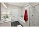 This bathroom features a tub, glass-enclosed shower, and a vanity with modern fixtures and finishes at 1029 Piedmont Ne Ave # 101, Atlanta, GA 30309