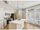 Sunlit kitchen with white cabinets, stainless steel appliances, and French doors at 1029 Piedmont Ne Ave # 101, Atlanta, GA 30309