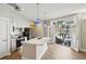 Well-lit kitchen featuring white cabinets, stainless appliances, and a large island with a sink at 1029 Piedmont Ne Ave # 101, Atlanta, GA 30309