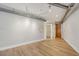 Living room with industrial-style lighting, hardwood floors, and frosted glass partition at 1029 Piedmont Ne Ave # 101, Atlanta, GA 30309