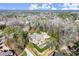 An aerial view of the home shows a wooded lot with an in-ground pool and circular driveway at 3128 Lower Roswell Rd, Marietta, GA 30068