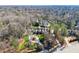 An aerial view of a large home on a wooded lot with mature trees and a circular driveway at 3128 Lower Roswell Rd, Marietta, GA 30068