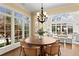 Bright breakfast nook featuring large windows, hardwood floors, and a round wooden table at 3128 Lower Roswell Rd, Marietta, GA 30068