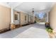 Covered parking area featuring a lantern, stone pillars and pavers, and a view of the manicured lawn and shrubs at 3128 Lower Roswell Rd, Marietta, GA 30068