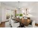 Bright dining room with wood table, stylish chairs, and French doors leading to the outdoors at 3128 Lower Roswell Rd, Marietta, GA 30068