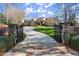 Elegant gated entrance with stone pillars and lush landscaping leading to a beautiful home at 3128 Lower Roswell Rd, Marietta, GA 30068