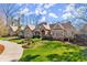 Beautifully landscaped front yard leading to a stately home with stone and neutral siding at 3128 Lower Roswell Rd, Marietta, GA 30068