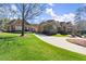 Expansive front lawn leading to an elegant home with a porte-cochere and stone accents at 3128 Lower Roswell Rd, Marietta, GA 30068