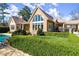 Beautiful exterior view of the home with a stone facade and large windows behind a neatly trimmed hedge at 3128 Lower Roswell Rd, Marietta, GA 30068