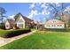 Lush front yard with manicured lawn, trimmed hedges, and a stone walkway leading to a stately home with great curb appeal at 3128 Lower Roswell Rd, Marietta, GA 30068