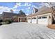 Exterior shot of home showcasing a three-car garage and a long driveway, exuding curb appeal and functionality at 3128 Lower Roswell Rd, Marietta, GA 30068