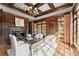 Cozy home office space with fireplace, coffered ceilings, and large windows showcasing backyard at 3128 Lower Roswell Rd, Marietta, GA 30068