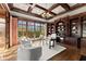 Elegant home office featuring custom wood built-ins, hardwood floors, and large windows for natural light at 3128 Lower Roswell Rd, Marietta, GA 30068