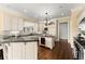 Well-lit kitchen with white cabinets, granite countertops, an island, and stainless steel appliances at 3128 Lower Roswell Rd, Marietta, GA 30068