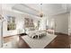 Bright main bedroom featuring neutral paint, tray ceiling, and beautiful hardwood floors at 3128 Lower Roswell Rd, Marietta, GA 30068