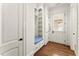 Bright mudroom boasts a built-in bench with storage and hardwood floors near an exterior door at 3128 Lower Roswell Rd, Marietta, GA 30068