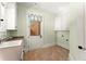 Mudroom featuring a utility sink, tiled floors, cabinet storage, and convenient access to the outside at 3128 Lower Roswell Rd, Marietta, GA 30068