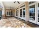 Outdoor covered patio featuring a stone floor and multiple french door entrances at 3128 Lower Roswell Rd, Marietta, GA 30068