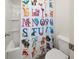 ' bathroom with tub and colorful shower curtain at 372 Garnet Dr, Acworth, GA 30101