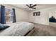 Bedroom with neutral carpet, ceiling fan, and window with blue curtains at 372 Garnet Dr, Acworth, GA 30101