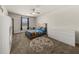 Bright bedroom featuring plush carpet, ceiling fan, and natural light from the window at 372 Garnet Dr, Acworth, GA 30101