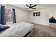 Comfortable bedroom with soft carpeting, ceiling fan, and a bright window with blinds at 372 Garnet Dr, Acworth, GA 30101