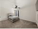Cozy bedroom featuring neutral carpet, ceiling fan, and a bed with a gray headboard at 372 Garnet Dr, Acworth, GA 30101