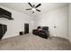 Carpeted bonus room featuring a ceiling fan, black leather sofa, and wall-mounted television at 372 Garnet Dr, Acworth, GA 30101