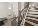 Bright entryway featuring wooden staircase with metal railings, a pendant light, and seating area at 372 Garnet Dr, Acworth, GA 30101