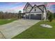 Beautiful two-story home featuring a three-car garage, well-manicured lawn, and modern architectural details at 372 Garnet Dr, Acworth, GA 30101