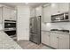 Modern kitchen features stainless steel appliances and gray cabinets at 372 Garnet Dr, Acworth, GA 30101