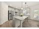 Modern kitchen with gray cabinets, granite countertops, and stainless steel appliances at 372 Garnet Dr, Acworth, GA 30101