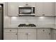 Contemporary kitchen showcasing stainless steel appliances, stone counters, and modern cabinetry at 372 Garnet Dr, Acworth, GA 30101