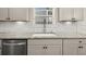 Close-up of a kitchen featuring granite countertops, stylish backsplash, and stainless steel appliances at 372 Garnet Dr, Acworth, GA 30101