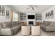 Bright living room features two sofas, chairs, and shelves with decor at 372 Garnet Dr, Acworth, GA 30101