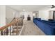 Bright loft with a blue sectional couch, neutral carpet, and views to the bedrooms at 372 Garnet Dr, Acworth, GA 30101