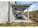 Side view of an outdoor patio with a gray pool table beneath a pergola at 372 Garnet Dr, Acworth, GA 30101