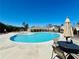 Wide shot of a community pool with lounge chairs and umbrellas on a sunny day at 372 Garnet Dr, Acworth, GA 30101