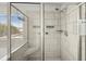 Walk-in shower with a glass enclosure, white tile, and shower seating at 372 Garnet Dr, Acworth, GA 30101