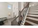 Elegant staircase with wood treads, iron balusters, and a view to the entry at 372 Garnet Dr, Acworth, GA 30101