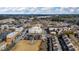 Aerial view of a city with a central park, surrounded by residential and commercial buildings at 3862 Memphis Dr, Suwanee, GA 30024