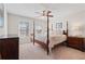 Cozy bedroom with natural light, ceiling fan, and hardwood furniture at 3862 Memphis Dr, Suwanee, GA 30024