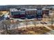 Aerial view of buildings, restaurants, shops, apartments, parking, and decorative trees at 3862 Memphis Dr, Suwanee, GA 30024