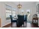 Bright dining area with a modern light fixture and outdoor view at 3862 Memphis Dr, Suwanee, GA 30024