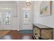 Elegant foyer with hardwood floors, a decorative console table, and a view of the front door at 3862 Memphis Dr, Suwanee, GA 30024